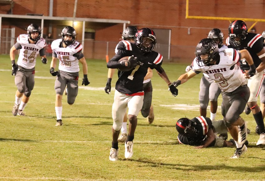 Philadelphia’s Jacarey Clemons (51) leads the way for quarterback Marcus Beamon during the Tornadoes game with West Lauderdale.